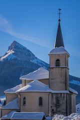 View on the church of Saint Pierre de Chartreuse and the Chamechaude peak covered in snow in the French Alps