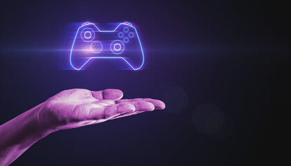 Closeup of male hand pointing at creative joystick or gamepad hologram on blurry purple bokeh...