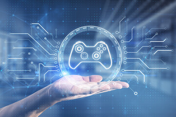 Close up of businessman hand holding creative joystick or gamepad hologram on blurry office interior background. Esport, gaming and fun concept. Double exposure. © Who is Danny