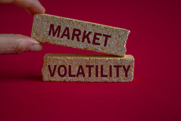 Market volatility symbol. Concept words Market volatility on brick blocks. Beautiful red...