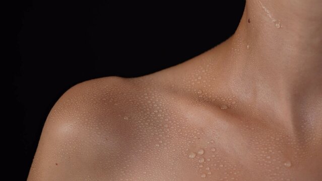 Closeup Shot Of Caucasian Woman Body Part In Studio Light, Shoulder And Collarbone Area Skin In Water Drops After Showering.