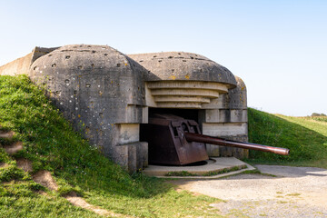 A bunker holding a 150 mm gun in the Longues-sur-Mer battery in Normandy, France, a WWII German coastal artillery battery part of the Atlantic Wall fortifications. - obrazy, fototapety, plakaty