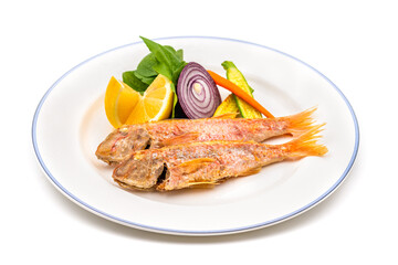 Delicious grilled red mullet fish with garnishes like lemon, greens and onions