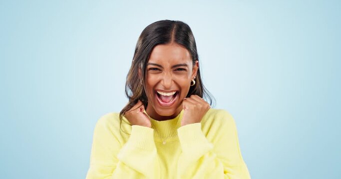 Happy, excited woman and wow face in studio with celebration from achievement with blue background. Smile, success and female person with winner yay, cheer and good news of promotion or winning