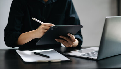 business documents on office desk with laptop and smart phone and graph business diagram and man working in office.