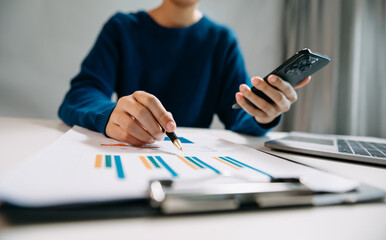 businesswoman working with digital tablet computer and smart phone with financial business strategy layer effect on desk