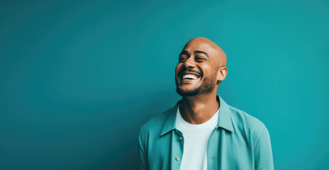Fototapeta premium Man laughing uncontrollably against a bright teal background - Infectious laughter - AI Generated