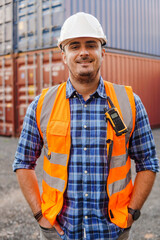 Portrait of happy container man worker in container warehouse. Import and export shipping....