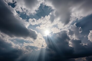 The sun shining through clouds in the sky