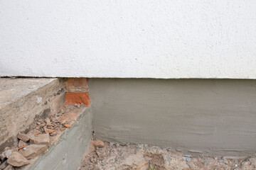 Building renovation. The foundation, the porch from which the brick is removed. Photo of the building from the outside of its porch, foundation.