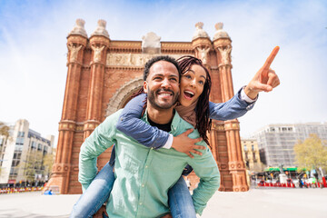 Beautiful happy hispanic latino couple of lovers dating outdoors - Tourists in Barcelona having fun...