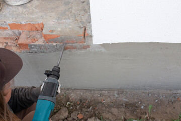 Building renovation. Removing red brick from the foundation.