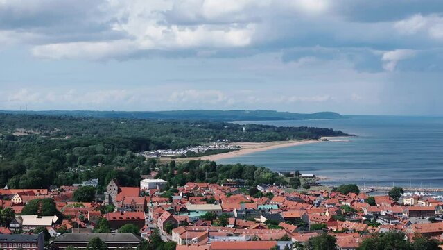 Telephoto aerial of scenic landscape behind rooftops of city Simrishamn, Sweden