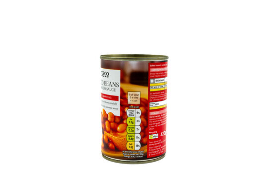 Irvine, Scotland, UK-July 21, 2023: Tesco branded baked beans in tomato sauce contained in a recyclable tin can with graphics icons and symbols relevant to the product