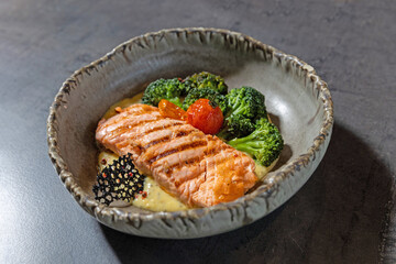 Grilled salmon served with vegetables