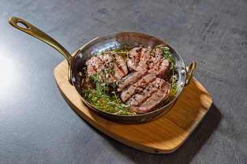Grilled beef served in olive oil with herbs