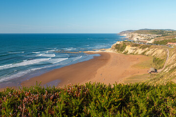 Landscape of sandy beach Sopelana near Bilbao, Basque country, Spain. Coastline with cliffs in...