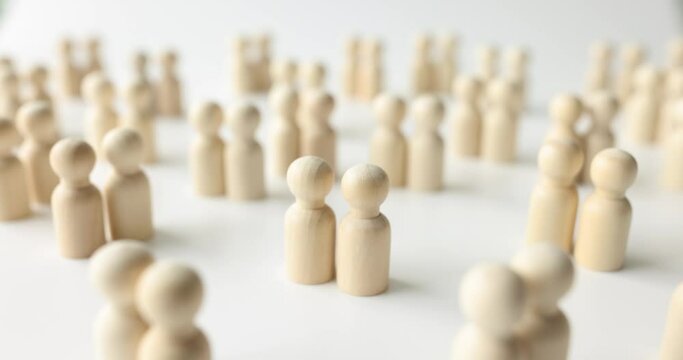 Many pairs of female and male wooden human figurines. Finding a partner love and family