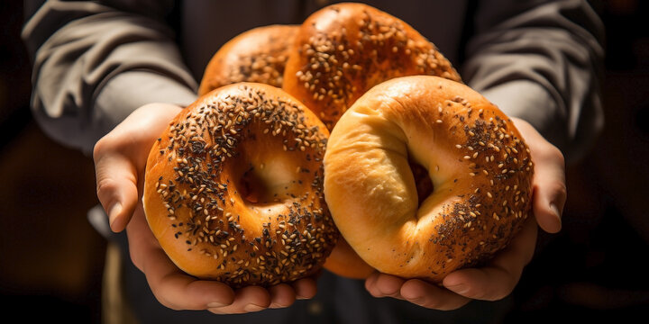 Close up of hands of non recognizable people handling American bagels.