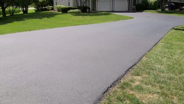 View of Driveway after sealcoating pavement, Near private houses in the suburbs