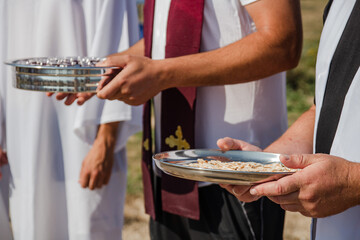 Holy Supper, Baptism. Wine and bread. Christian traditions. Pastors distribute Holy Communion.