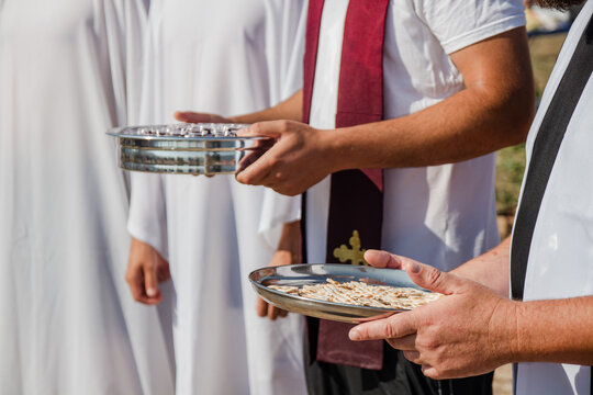 Holy Supper, Baptism. Wine and bread. Christian traditions. Pastors distribute Holy Communion.