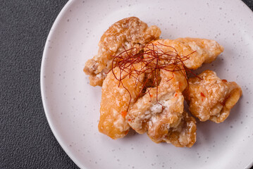 Delicious juicy grilled chicken pieces in sweet and sour sauce with salt and spices