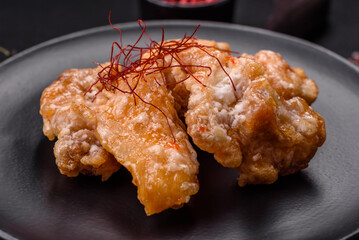 Delicious juicy grilled chicken pieces in sweet and sour sauce with salt and spices