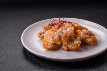 Delicious juicy grilled chicken pieces in sweet and sour sauce with salt and spices