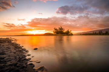 Landscape photograph of a sunset on the beach of a pond on Reunion Island.