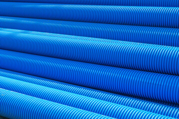 Blue plastic drain pipe with thread. Corrugated sewer pipes of large diameter. Drainage pipes for...