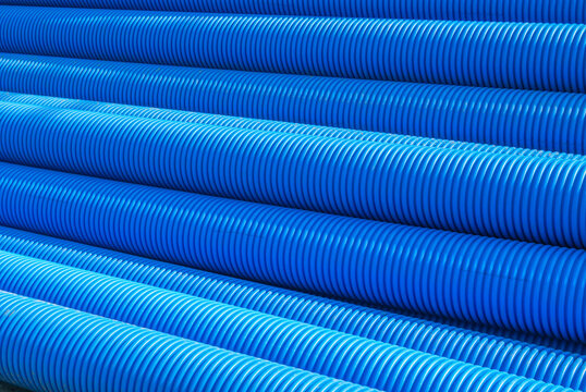 Blue plastic drain pipe with thread. Corrugated sewer pipes of large diameter. Drainage pipes for groundwater drainage. Drainage during road construction.
