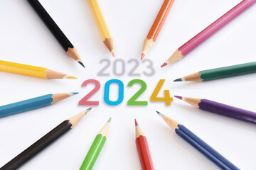 2023 to 2024 with colored pencils isolated on white background.  Business teamwork concept and synergy connection idea