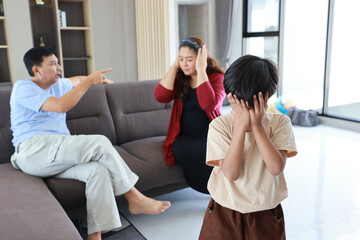 Young little asian boy depressed and upset while parent fighting and arguing - obrazy, fototapety, plakaty