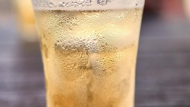 Water droplets on beer glass in festive Christmas and New Year celebration concept.