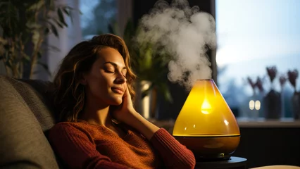 Poster Person resting using essential oil diffuser during autumn cold recovery  © fotogurmespb
