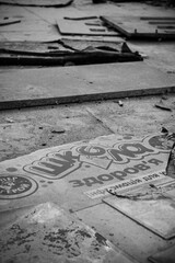 on the floor of the broken school there is a stand that reads 