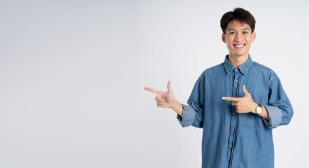 Portrait of Asian male  posing on white background - obrazy, fototapety, plakaty