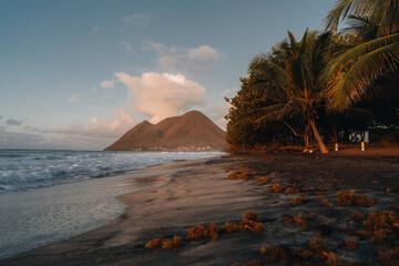 Dramatic seascape landscape of the beautiful wild tropical Diamant beach with its layered woman...