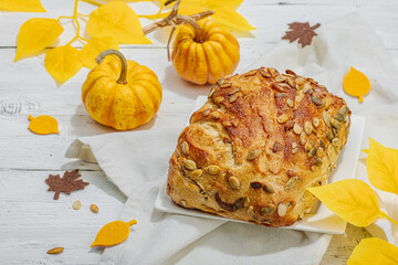Fresh bread with pumpkin seeds. Home baking concept. Autumn decor