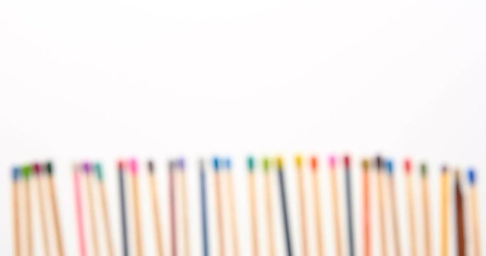 Still shot of colored matchsticks, with shallow depth of field and focus transition