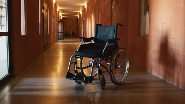 No people interior shot of wheelchair in old psychiatric hospital corridor, copy space