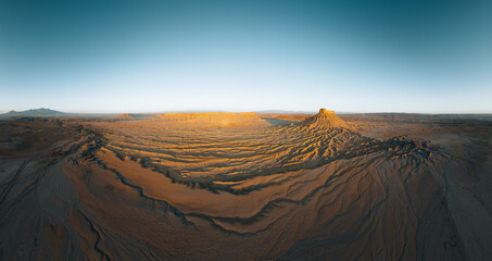 Fototapeta na wymiar Factory Butte in the Caineville Badlands of Utah. Aerial drone panorama during sunrise.