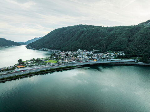 Aerial view of a road crossing the Lugano lake at sunset, Melide, Ticino, Switzerland.