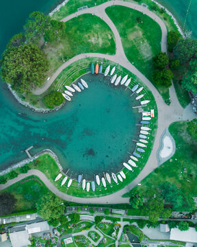 Aerial view of sailing boats docked along the pier in Melide, a small town along the Lugano Lake in Ticino, Switzerland.