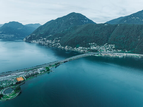 Aerial view of a road crossing the Lugano lake at sunset, Melide, Ticino, Switzerland.