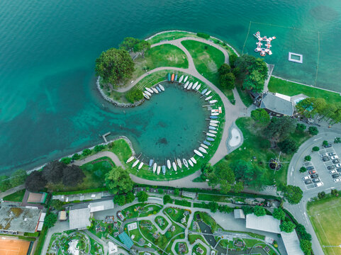 Aerial view of sailing boats docked along the pier in Melide, a small town along the Lugano Lake in Ticino, Switzerland.