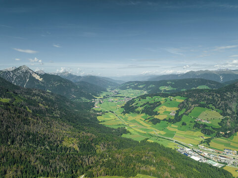 Aerial view of Dobbiaco town as seen from Croda dei Baranci (Birkenkofel) mountain peak on the Dolomites range, Trentino, South Tyrol, Italy.