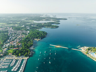 Aerial view of sailboats along the Adriatic sea coastline near Porec, Istria, Croatia.