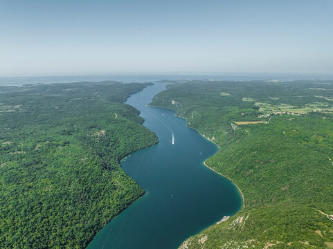 Aerial view of boats sailing along the Limski Fjord (Canal di Leme) in Sveti Lovrec, Istria, Croatia.